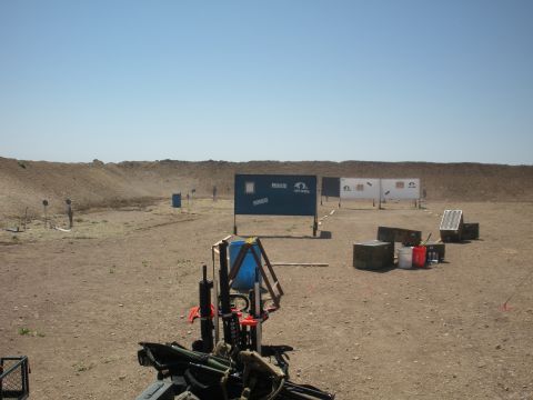 1996 Ford Bronco - A wide view of an outdoor shooting range under a clear blue sky, various targets and shooting stations.