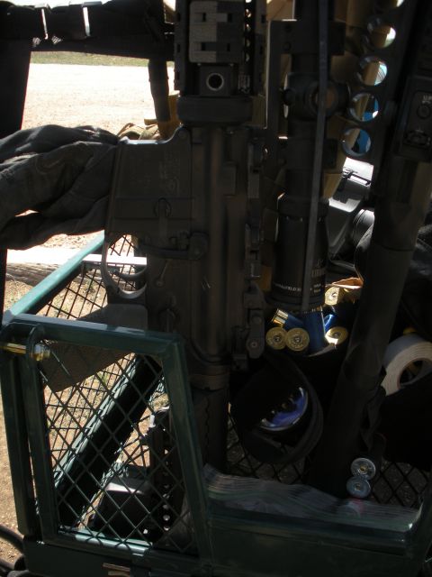 1996 Ford Bronco - Close-up of an assault rifle with ammunition, placed inside a metal basket.