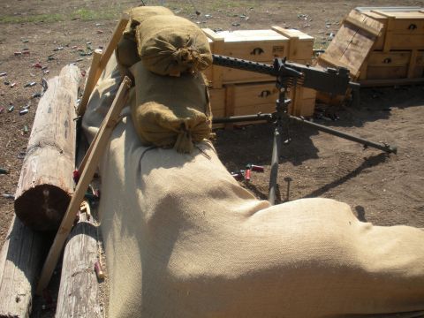 1996 Ford Bronco - A defensive position with a mounted machine gun and ammunition crates is set up outdoors.