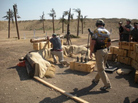1996 Ford Bronco - Participants engage in tactical training at an outdoor shooting range, utilizing various obstacles for cover.