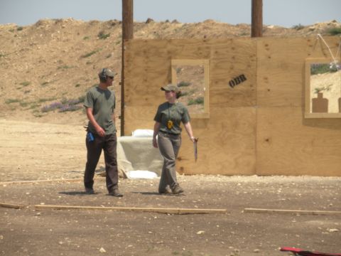 1996 Ford Bronco - Two individuals are present at an outdoor shooting range with a wooden backstop and targets.