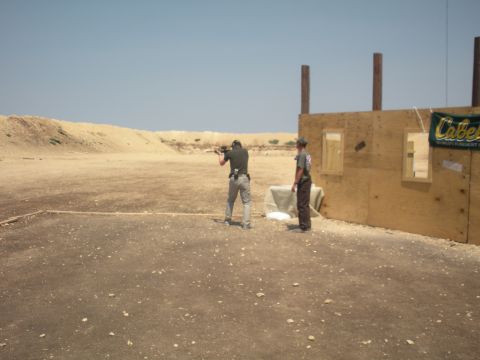 1996 Ford Bronco - Two people are at a shooting range with a wooden structure in the background.