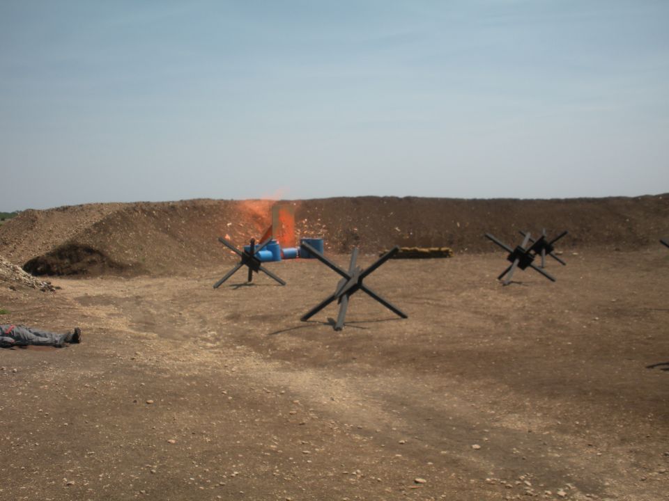 Target practice scene with dummy and anti-tank obstacles