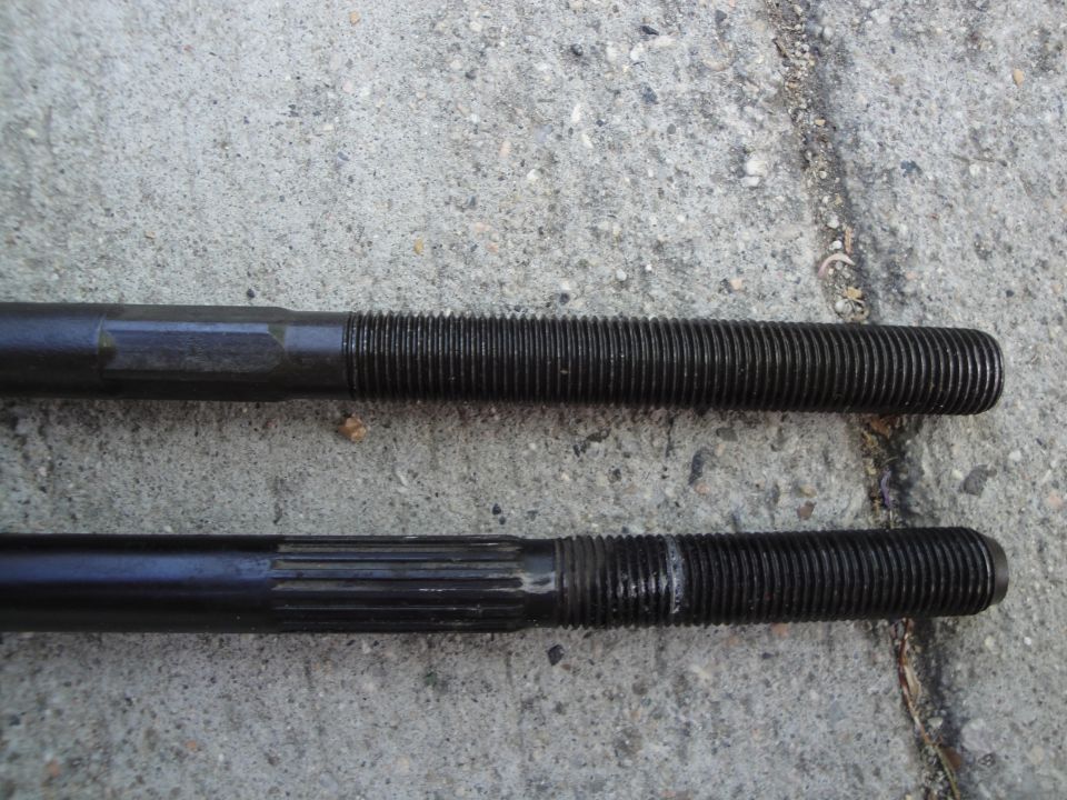 Two black threaded rods, one with splines on the shaft