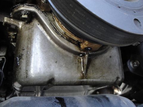 2003 Ford Taurus - Oil pan is leaking, indicating a potential maintenance issue.