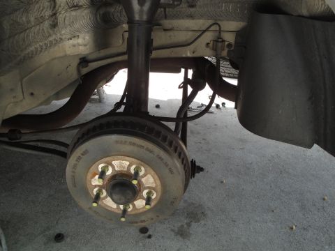 2003 Ford Taurus - Close-up view of a vehicle's rear brake rotor and suspension assembly.