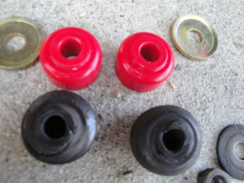 Red and black bushings with washers on concrete