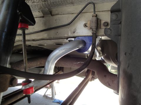 2003 Ford Taurus - Close-up of a vehicle's undercarriage, focusing on suspension parts like the sway bar and bushings.
