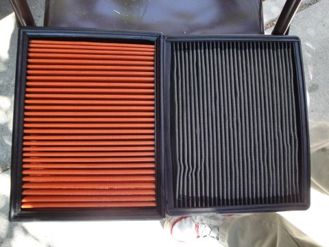 2003 Ford Taurus - Comparison of a new air filter and a used one, showing the difference in cleanliness and color.