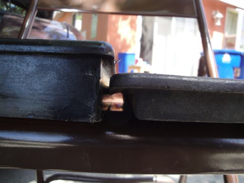 2003 Ford Taurus - The photo shows a close-up of two black plastic components, one with a textured surface.