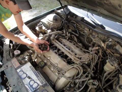 2003 Ford Taurus - Person holding a handful of carbon deposits removed from the engine of a 2003 Ford Taurus.