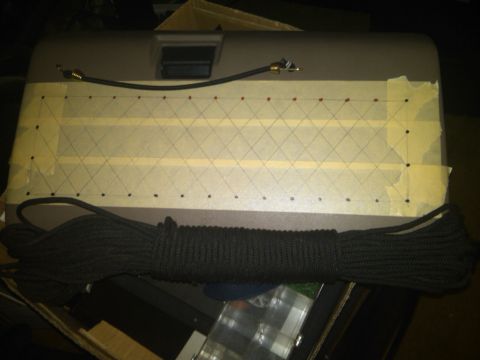 1993 Ford Bronco - A gray car part is marked with a taped grid and has a coiled rope on top.