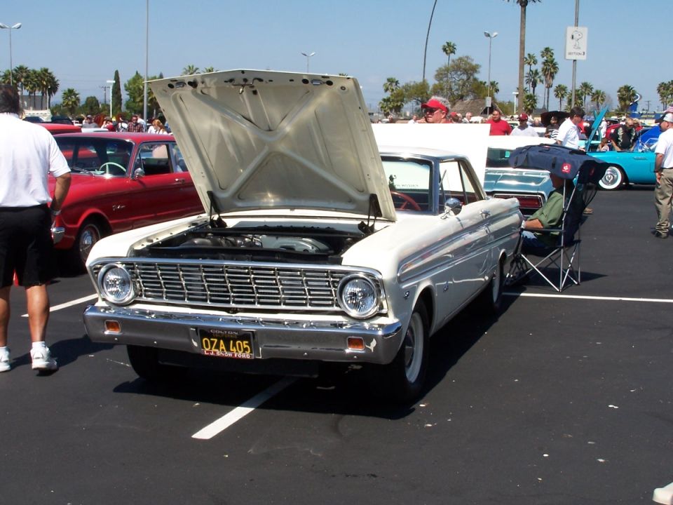 White 1960 Ford Falcon with hood open, license plate OZA 405. Red car behind it