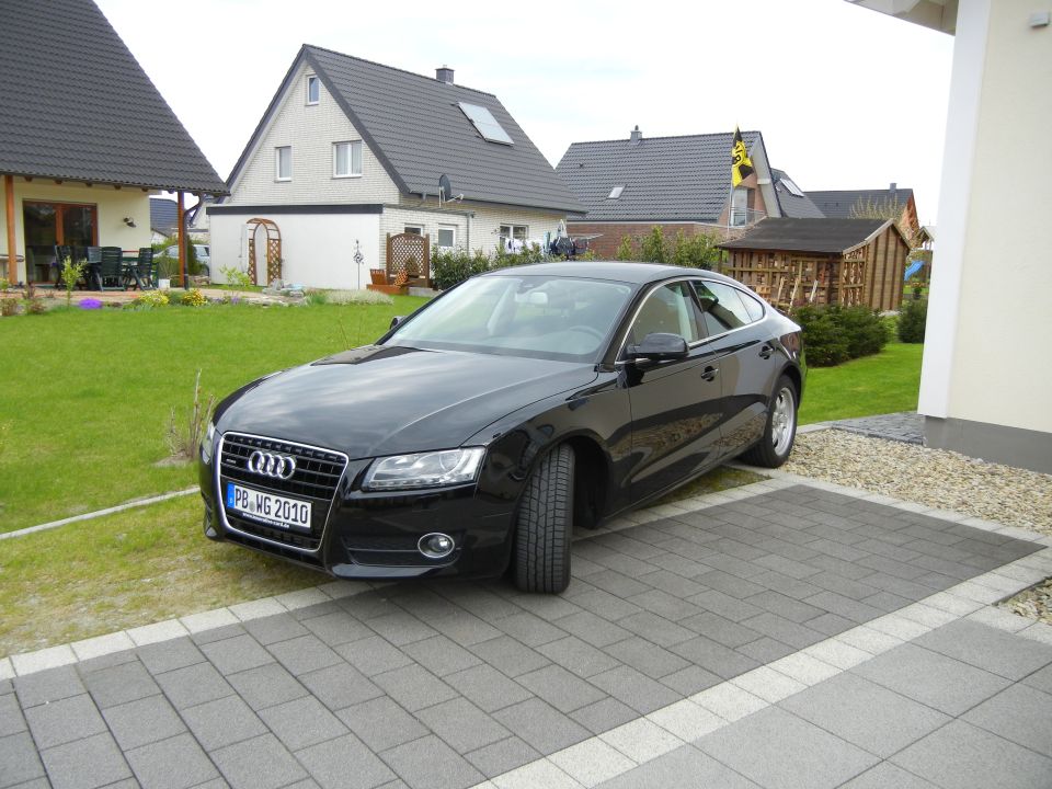 Black Audi A5 coupe with license plate PB-WG 2010 parked in driveway