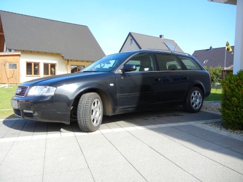 2003 Audi A6 - A dark station wagon is parked on a paved driveway with a house in the background.