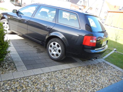 2003 Audi A6 - This 2003 Audi A6 Avant is parked on a paved driveway with gravel and landscaping.