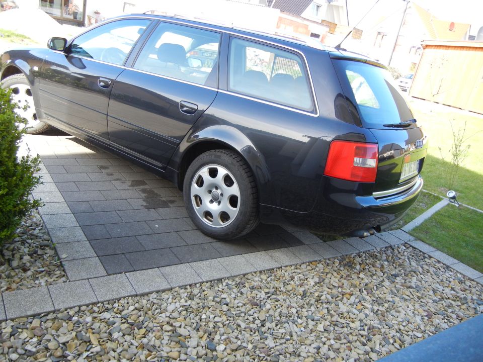 Dark blue 2003 Audi A6 Avant parked on a paved driveway