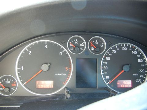 2003 Audi A6 - Close-up of a car's dashboard gauges, including a speedometer and tachometer, with a digital odometer reading.