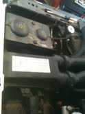 1988 Ford Bronco - Close-up of the engine bay in a 1988 Ford Bronco, showing various components and a label.