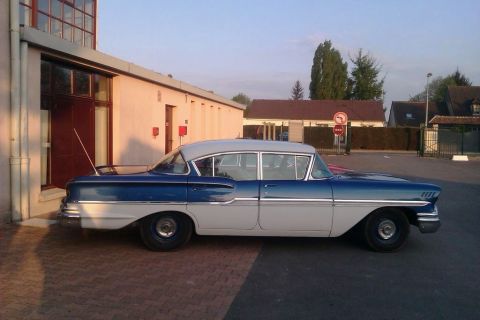 1991 Ford LTD Crown Victoria - Side view of a two-tone blue and white sedan, likely from 1958.