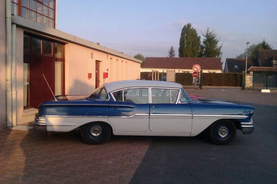 Blue and white 1958 sedan, side view