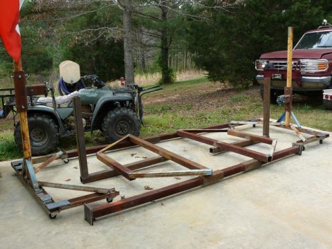 1976 Chevrolet Corvette - A red pickup truck is parked behind a disassembled metal frame and an ATV.