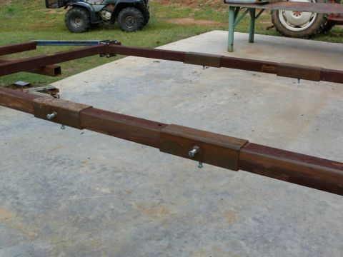 1976 Chevrolet Corvette - A metal frame structure is shown on a concrete surface, with an ATV visible in the background.