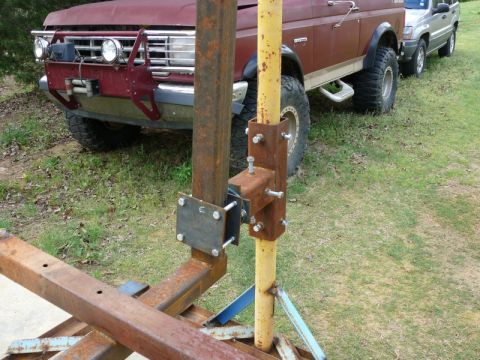 1976 Chevrolet Corvette - A close-up of a metal structure with two vehicles parked behind it.