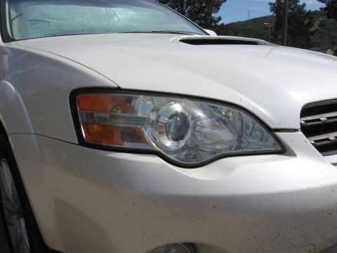 1993 Toyota 4Runner - Front view of a white Subaru Outback, showing the headlight and grille detail.