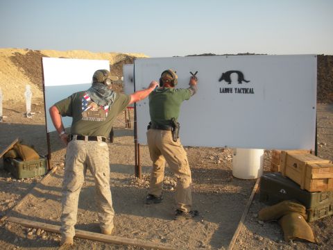 1996 Ford Bronco - Two individuals are engaged in target practice at an outdoor shooting range under a clear sky.