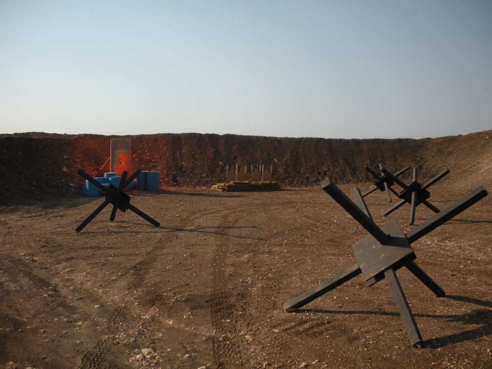 Shooting range with anti-tank obstacles and targets in the background