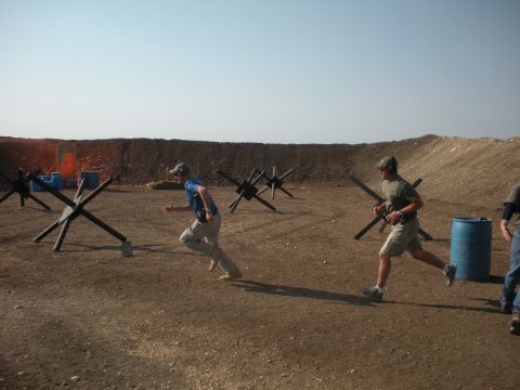 1996 Ford Bronco - Participants navigate a tactical course, dodging obstacles and moving towards targets on a sunny day.