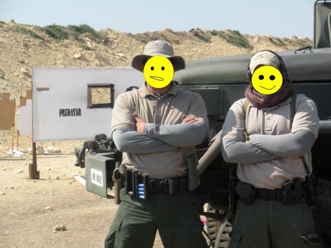 1996 Ford Bronco - Two men stand in front of a military vehicle at a desert shooting range.
