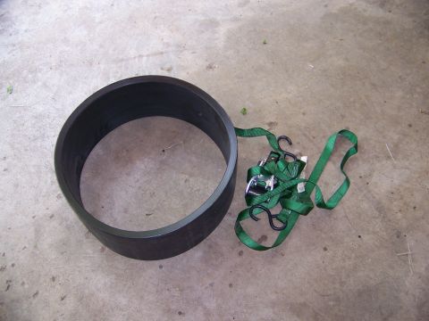 2001 Dodge 1500 - A black ring and green tie-down straps are visible on a concrete surface.