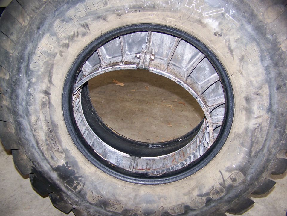 Tire with a metal double beadlock assembly inside, showing the inner rim and tire wall