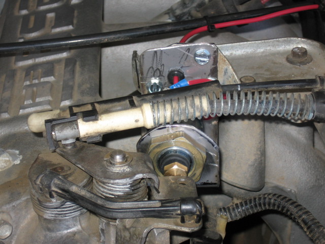 Fast-idle solenoid with brass plunger mounted at the throttle linkage of an engine