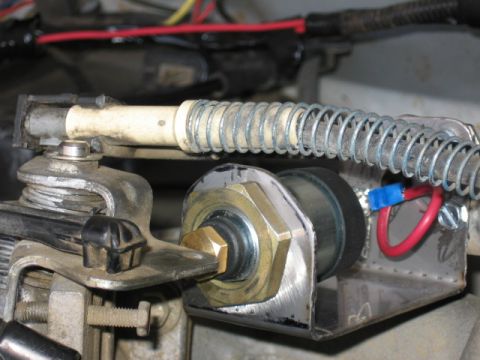 1995 Ford Bronco - Detail of a throttle linkage mechanism, a spring and electrical wiring.