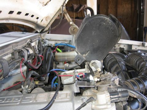 1995 Ford Bronco - Close-up of engine bay components, including air intake and brake fluid reservoir.