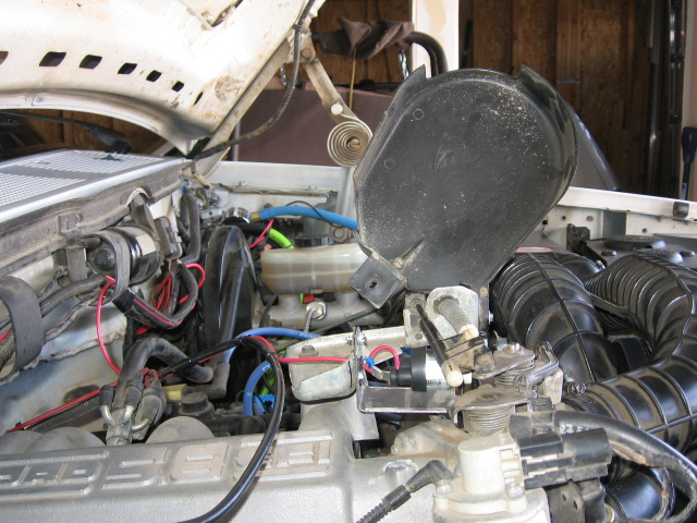 Ford 5.8 EFI engine bay with an added throttle actuator bracket and jumper wiring