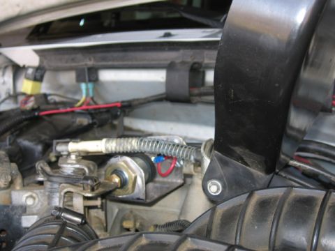 1995 Ford Bronco - Detail of engine compartment showing various mechanical and electrical components, including hoses and wiring harnesses.