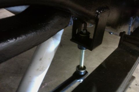 1994 Chevrolet Blazer - This image shows a close-up of a vehicle's suspension system, specifically a shock absorber attached to the frame.