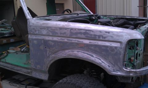 1995 Ford Bronco - This 1992 Ford Bronco is undergoing bodywork, with its original green paint stripped and primer applied.