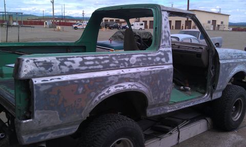 1995 Ford Bronco - This Ford Bronco is undergoing paint stripping, revealing primer and bare metal.