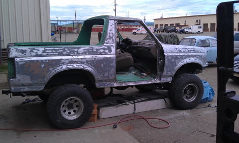 1995 Ford Bronco - This 1995 Ford Bronco is undergoing paint stripping, revealing its green interior and primer finish.