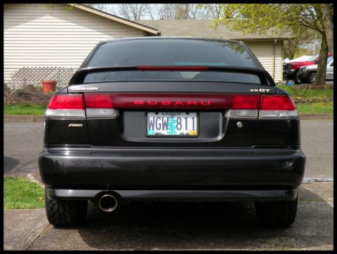 1998 Subaru Legacy - Rear view of a black 1998 Subaru Legacy sedan with a spoiler and Oregon license plate.