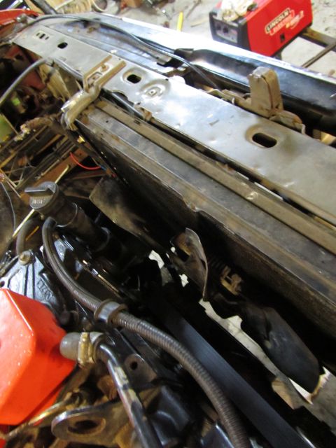 1984 Ford Bronco - Engine bay components including radiator, hoses, and fluid cap are visible in this close-up shot.