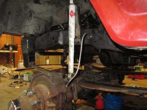 1984 Ford Bronco - This photo shows the underside of a vehicle, focusing on the suspension and frame components during what appears to be maintenance or repai…