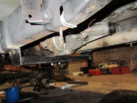 1984 Ford Bronco - Close-up view of the transfer case and frame components of a vehicle.
