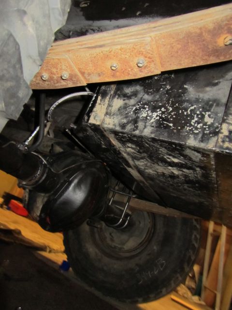1984 Ford Bronco - Close-up of vehicle undercarriage, focusing on suspension and drivetrain components.