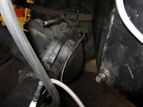 1984 Ford Bronco - Undercarriage view showing the rear axle assembly and suspension components of a vehicle.